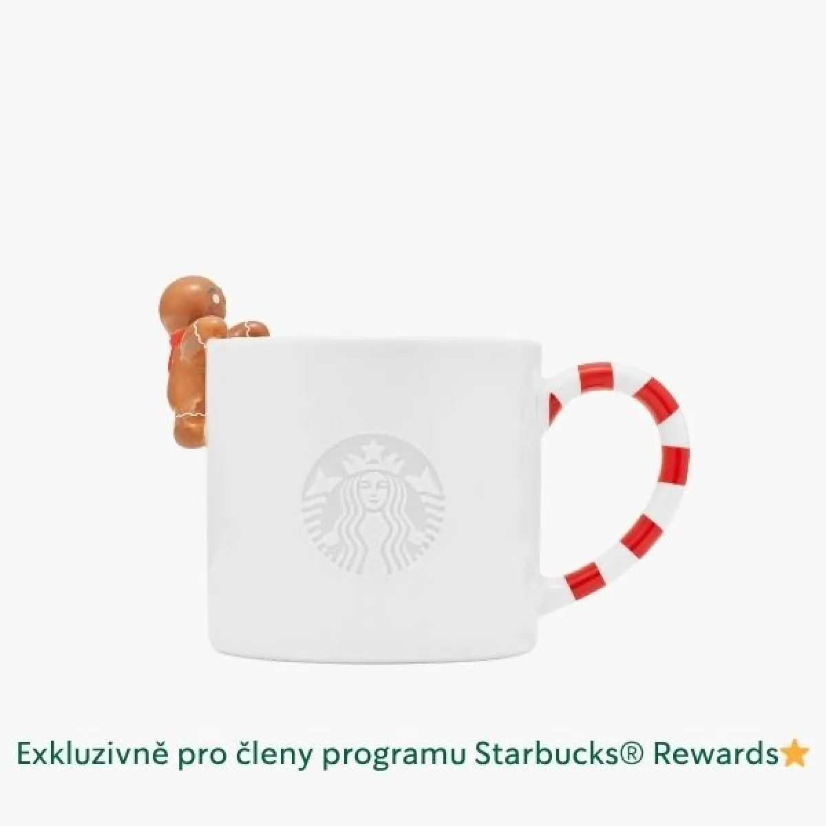 Bílý keramický hrnek s uchem ve tvaru červeno-bílé pruhované cukrové hůlky a malou figurkou perníkového panáčka přichycenou na okraji