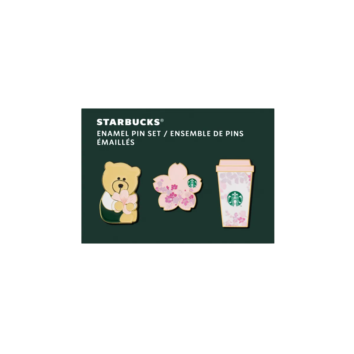 Sada tří smaltovaných odznaků na tmavém podkladu: medvídek, květ sakury a kelímek, všechny s jemným jarním motivem a detaily značky Starbucks.