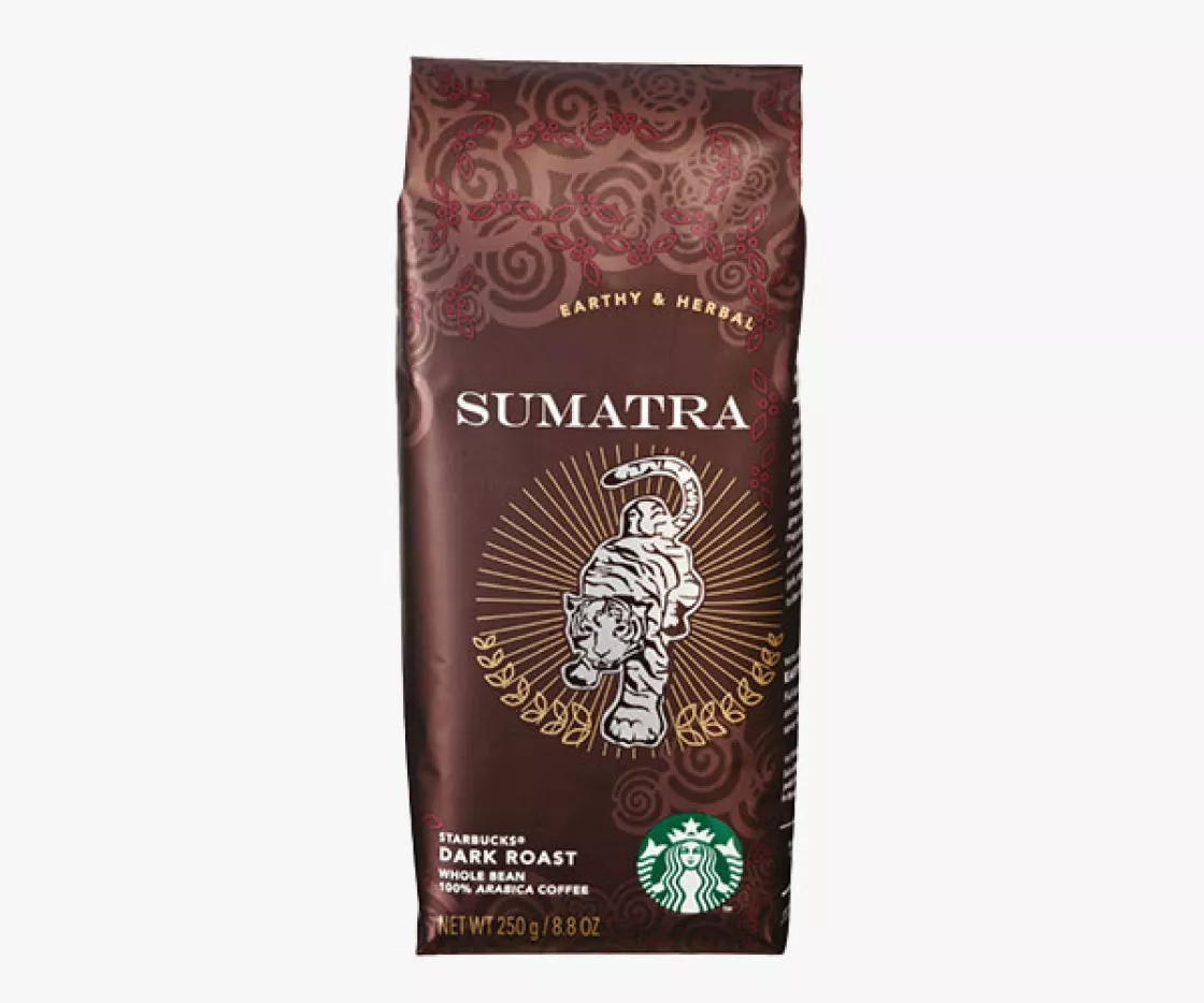 Dark brown package of starbucks whole bean coffee, white text on the package says "Sumatra". the package has a hand drawn sumatra tiger motif